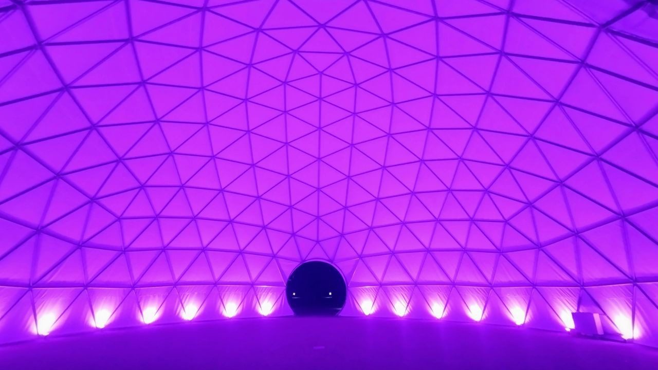 A purple dome with lights on the ceiling.