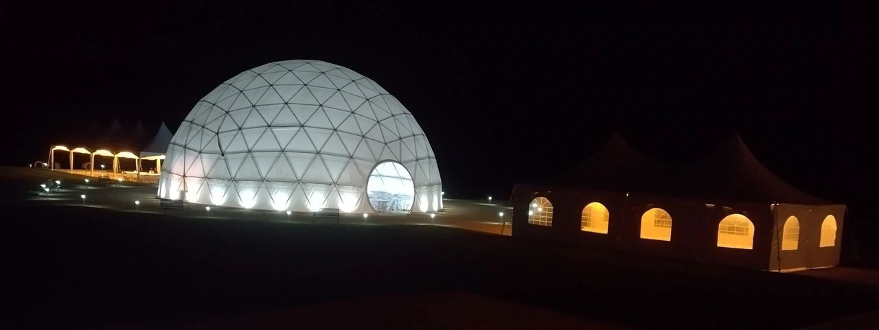 A large white dome with lights on top of it.