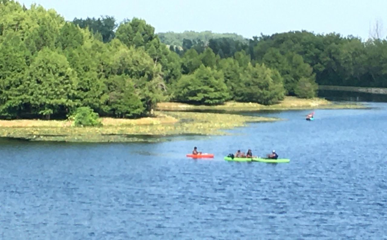 A group of people in kayaks on the water.