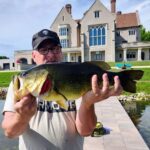 A man holding a large fish in his hands.