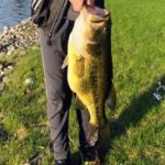 A man holding a large fish in his hand.