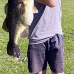 A man holding a large fish in his hands.