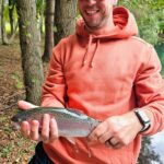 A man holding a fish in his hands.