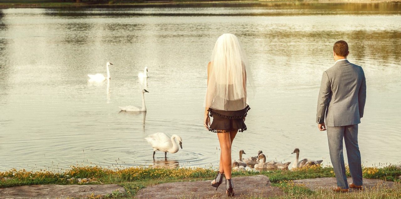 A woman standing in front of some ducks