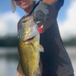 Person holding a large fish caught while fishing.